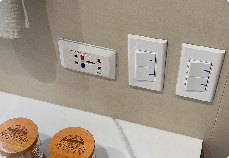 Bathroom vanity with wall panel and electrical outlet