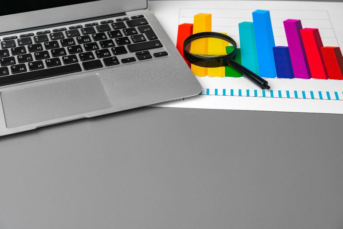 laptop and magnifying glass showing levels of competition