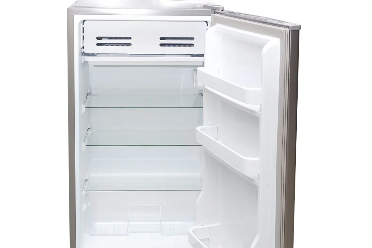 Compact refrigerator with open door, empty shelves, and built-in door storage.