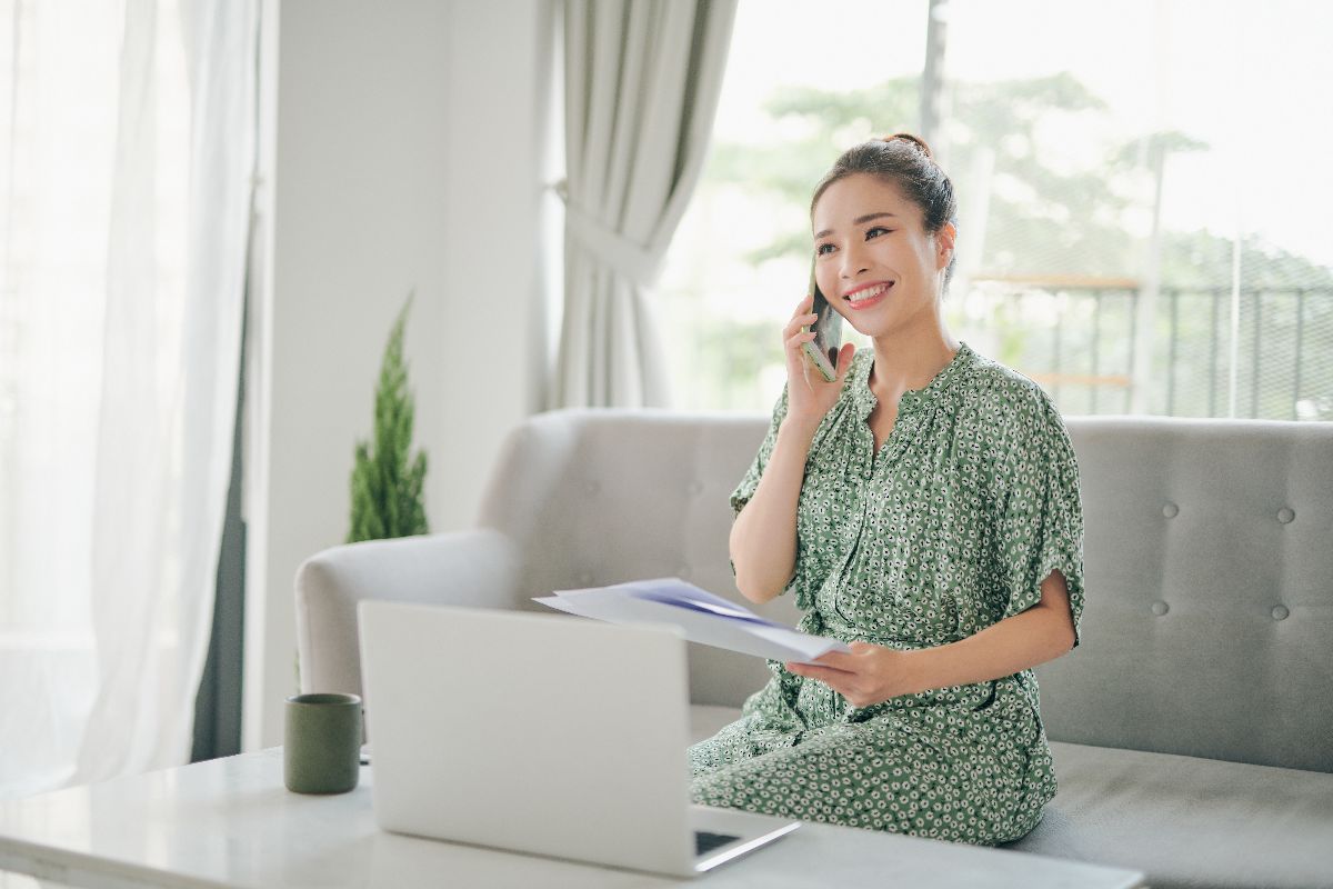 Filipina virtual assistant speaking with a client while reviewing documents