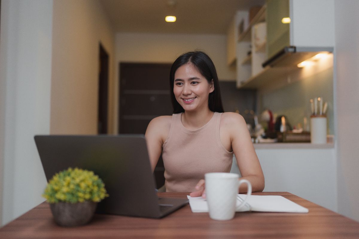 Remote social media management candidate working on a laptop at home