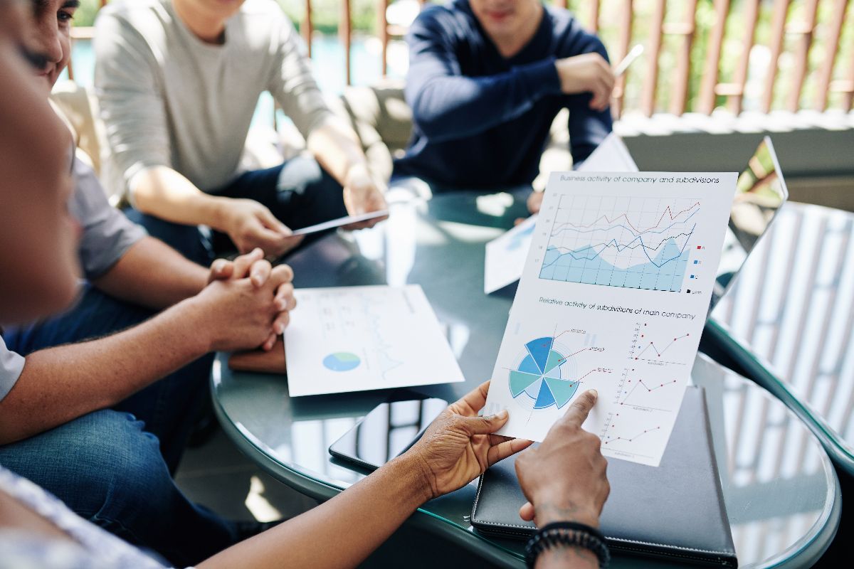 Team discussing performance charts during a strategy meeting about SEO and AEO visibility