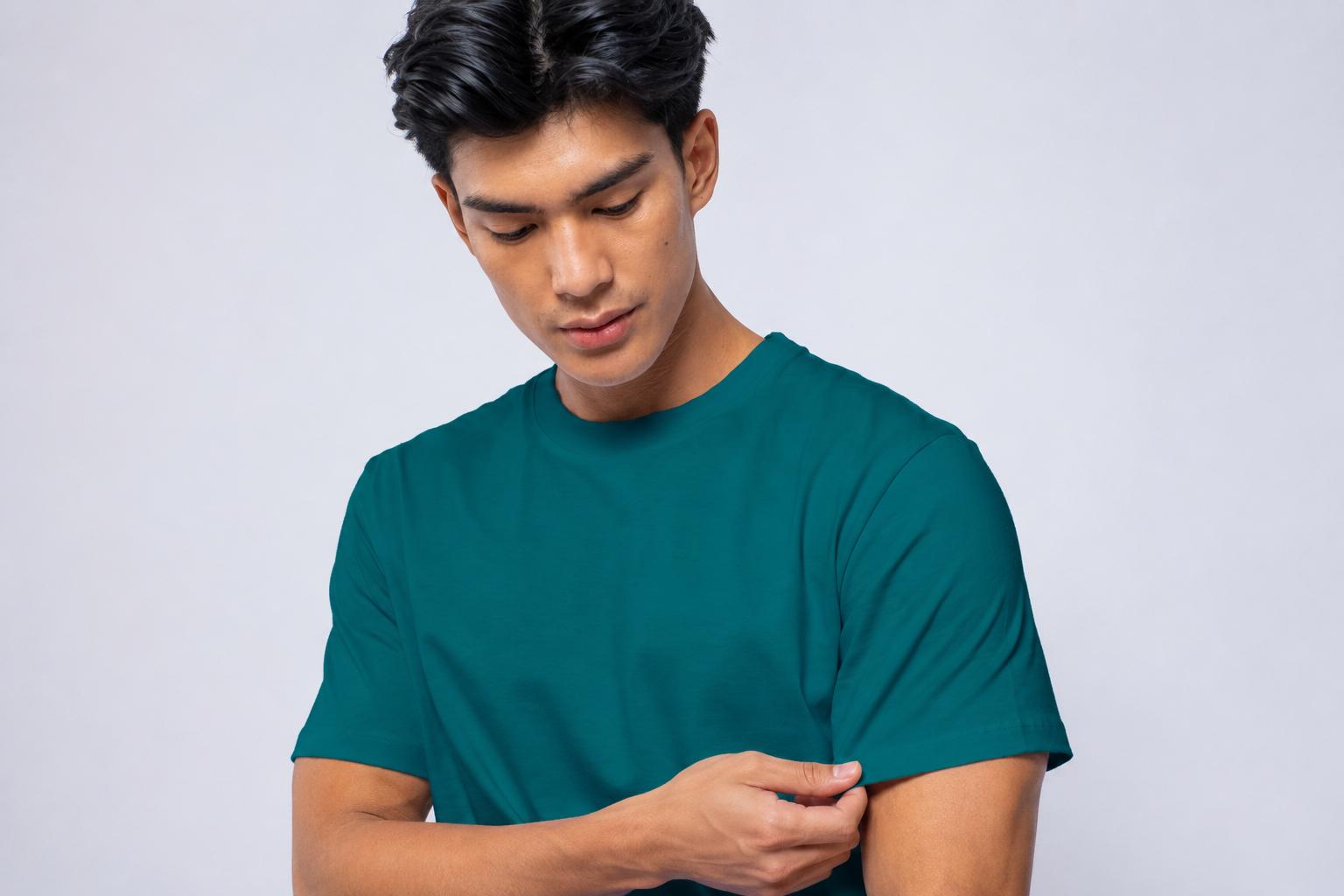 Male model wearing a teal plain shirt against a light studio background.