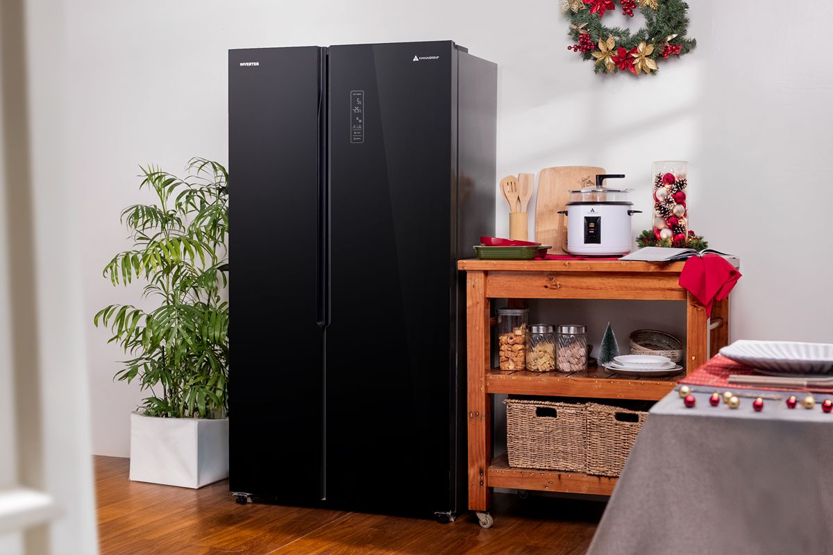 Black side-by-side refrigerator and rice cooker displayed in a festive kitchen with Christmas decorations