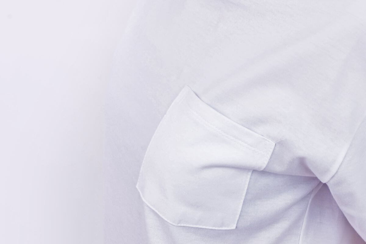 Close-up of white plain shirt fabric and sleeve stitching