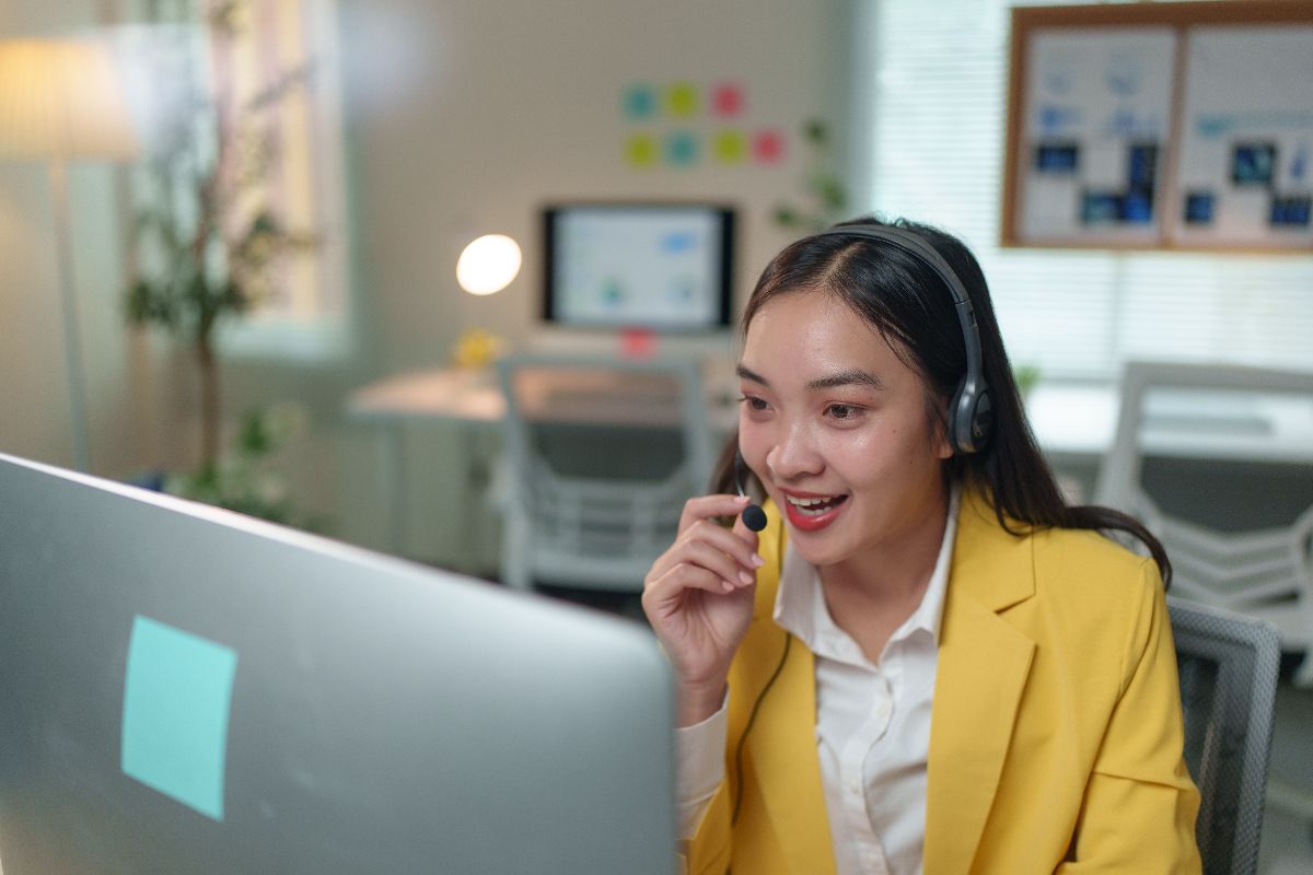 Filipina virtual assistant speaking through a headset while assisting a client online