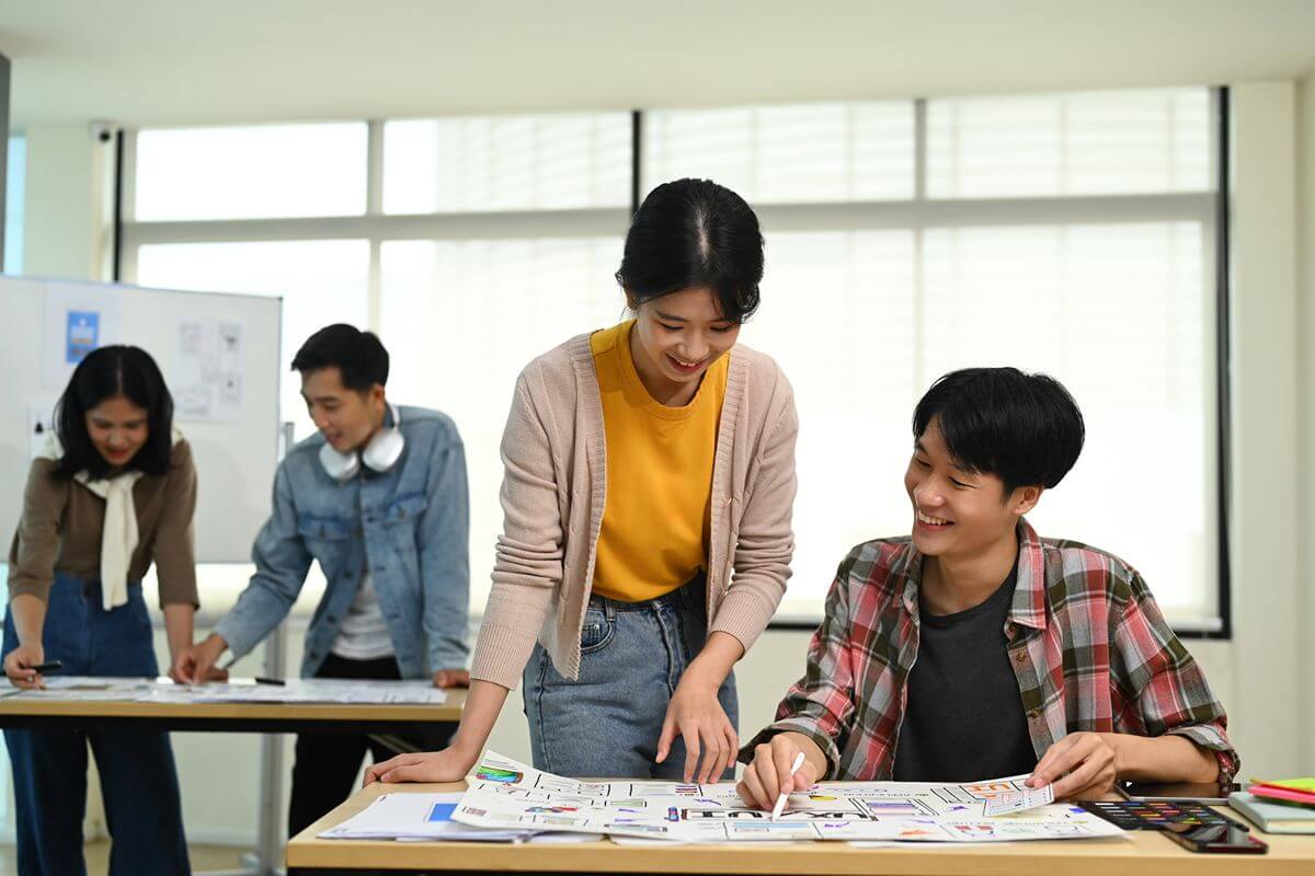 Senior high school students collaborate on project plans in a bright classroom