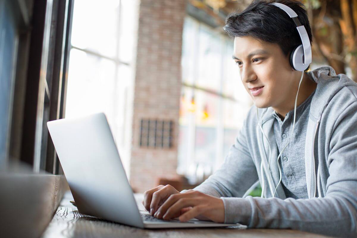 Student learns online with a laptop and headphones while developing career-ready skills