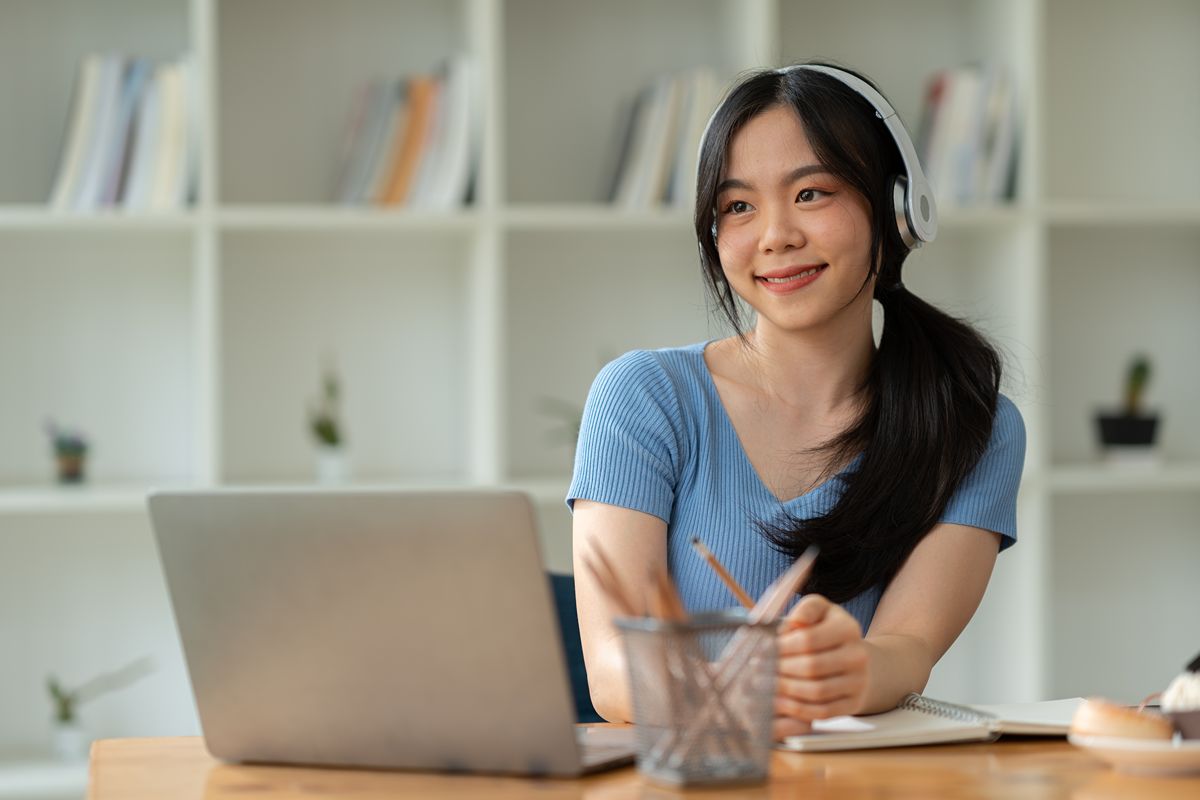 Real estate virtual assistant using a headset and laptop to manage administrative and operational tasks