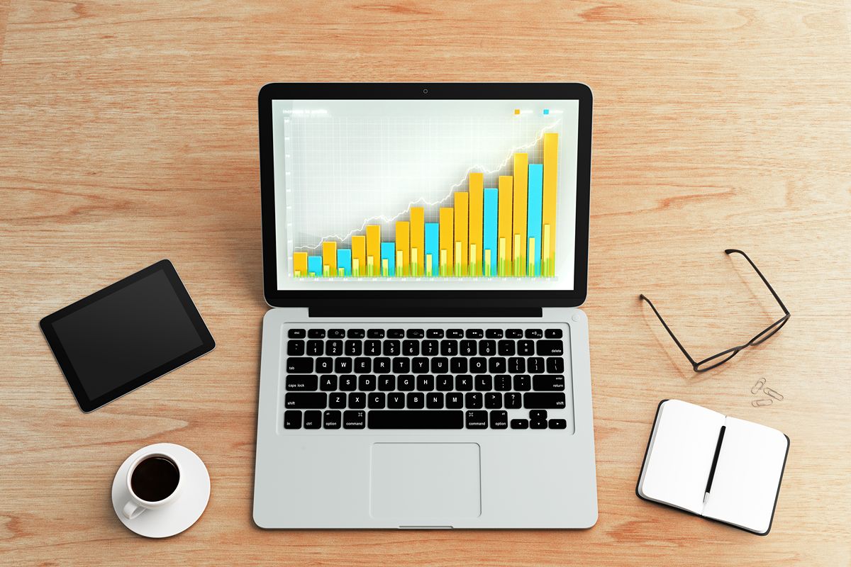 Laptop displaying a rising analytics chart, representing ranking factors such as content quality, backlinks, technical SEO, user experience, and search intent