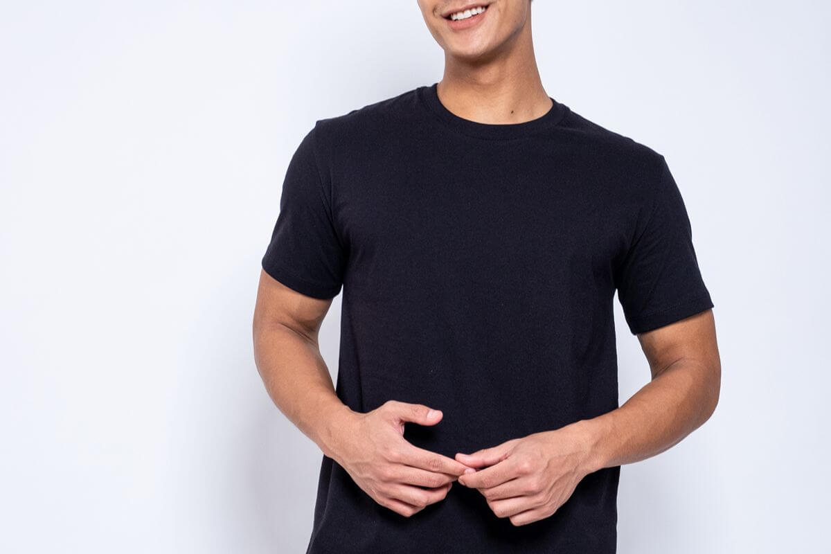 Male model wearing a black plain round neck shirt for supplier comparison