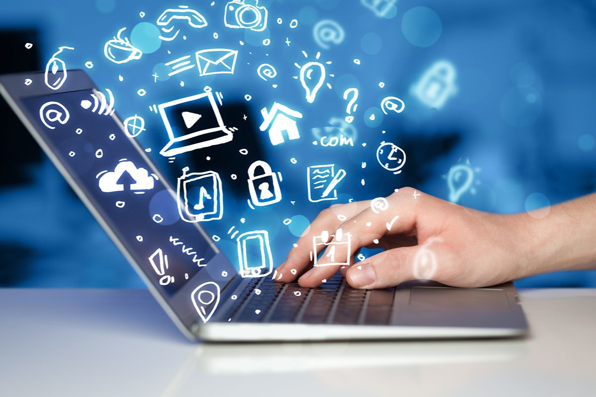Person using a laptop with digital communication and social media icons representing online marketing and content management