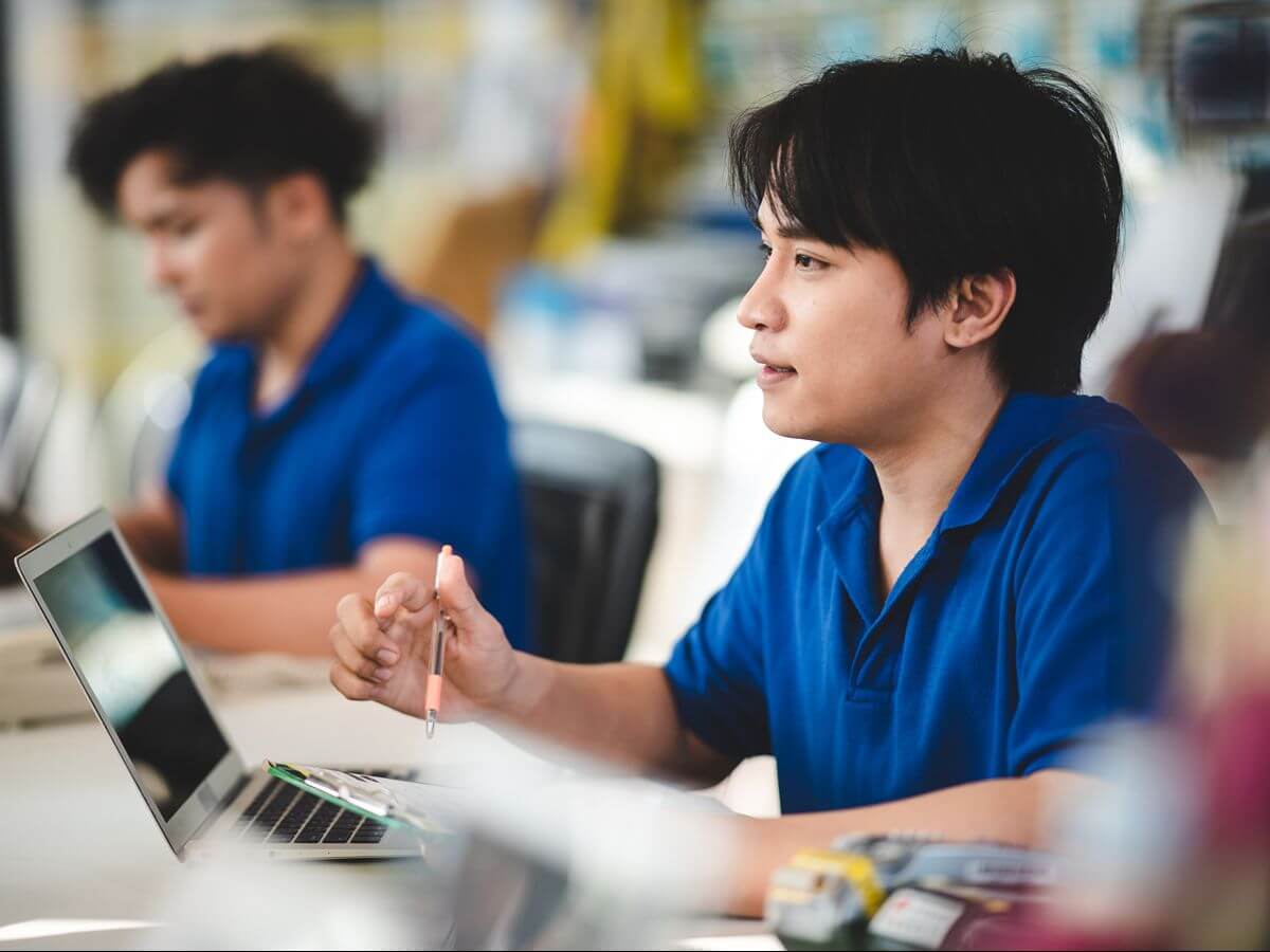 College student uses a laptop while exploring technology skills and short courses in a classroom