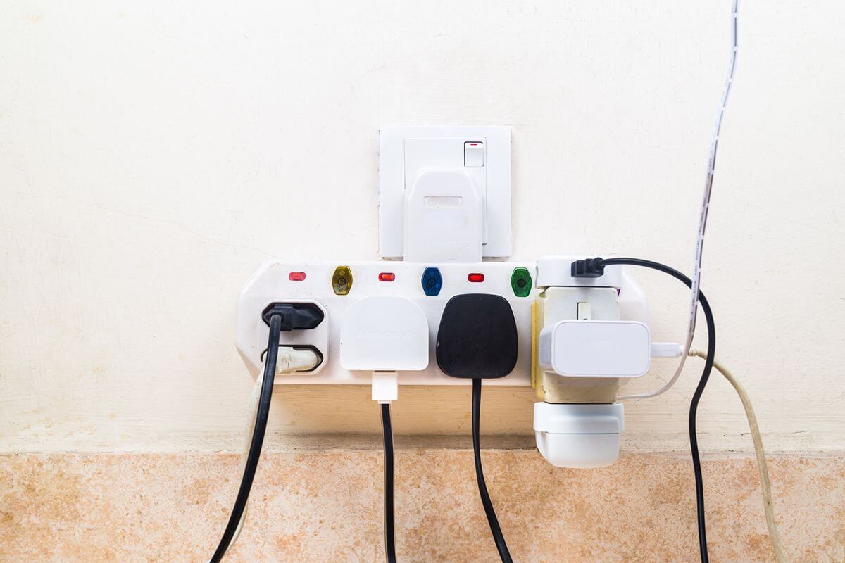 Electrical devices connected to a power outlet showing how voltage protectors help safeguard equipment from abnormal voltage levels